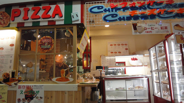 pizza stand next to a dessert store